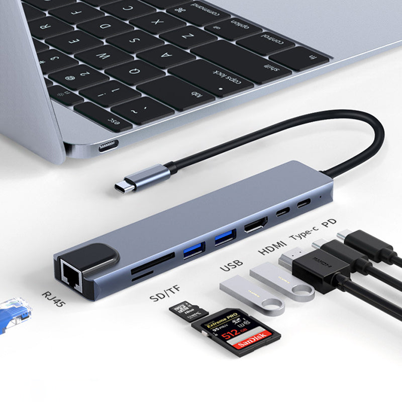 "8 i 1 USB-C dockningsstation i aluminium, modern design med flera portar för effektiv dataöverföring och laddning."