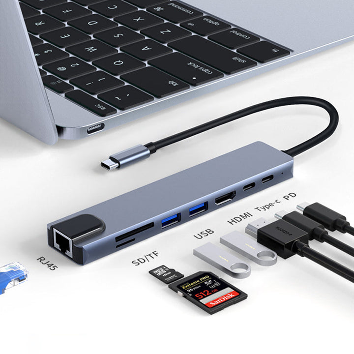 "8 i 1 USB-C dockningsstation i aluminium, modern design med flera portar för effektiv dataöverföring och laddning."