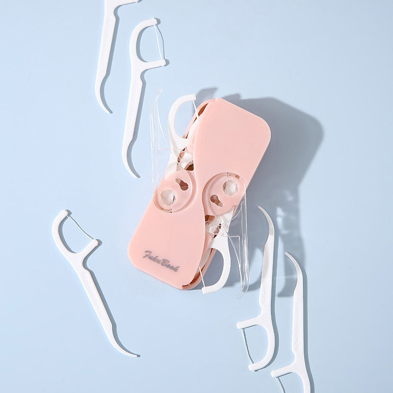 "Bärbar multifärgad tandtrådsdispenser, kompakt design i flera färger, idealisk för reser och dagligt bruk."