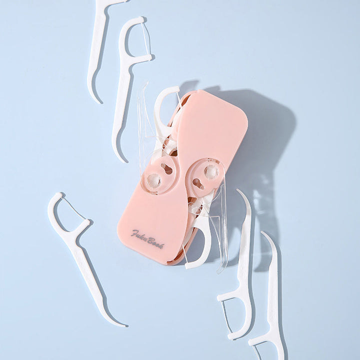 "Bärbar multifärgad tandtrådsdispenser, kompakt design i flera färger, idealisk för reser och dagligt bruk."