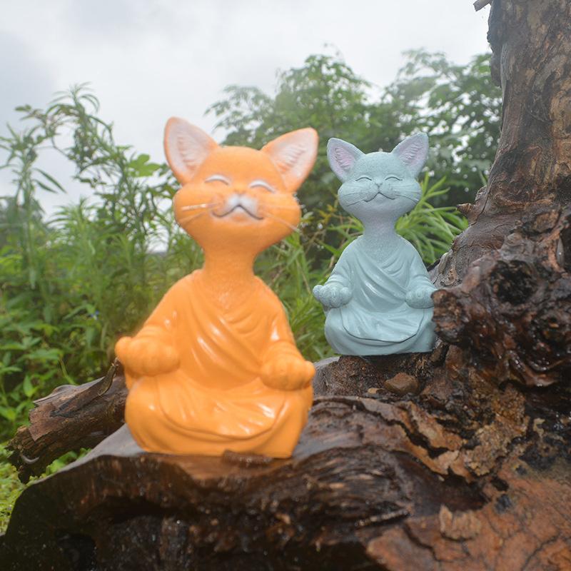 "Buddha prydnadskatt i harts, Zen dekoration med elegant design i svart, grå eller orange för hemmet."