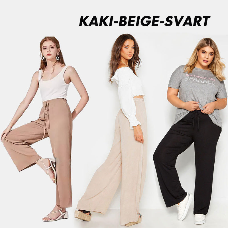 "Dam plus size vida byxor med hög midja, i silkesmjukt tyg och olika färger, elegant draperade för stil och komfort."