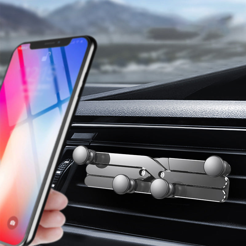 "Deformerande biltelefonhållare i svart, monterad i bilventilation, visar 360° rotation för enkel justering och sikt."