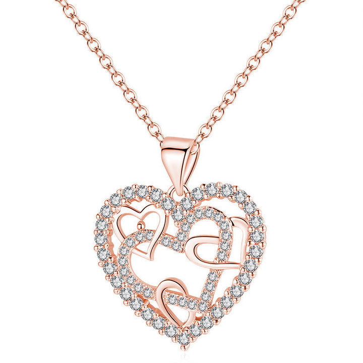 Dubbelhjärta halsband med gnistrande CZ-stenar, sammanlänkade hjärtan i roséguld och silver mot vit bakgrund.