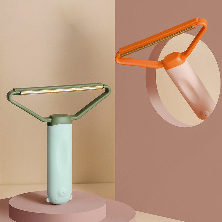 "Dubbelsidig luddskrapa i grön, ergonomisk design, effektiv för kläder, möbler och mattor, med mångsidig funktion."