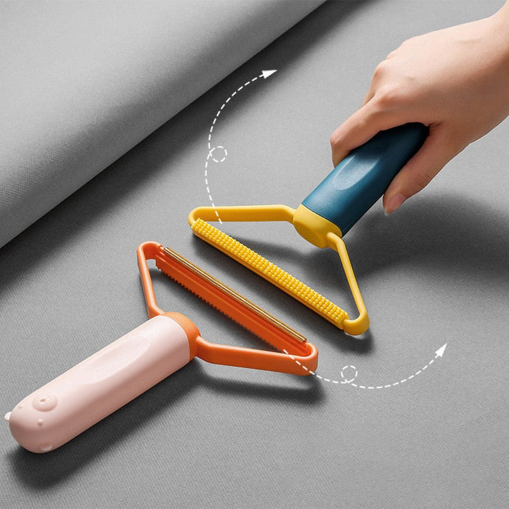 "Dubbelsidig luddskrapa i grön, ergonomisk design, effektiv för kläder, möbler och mattor, med mångsidig funktion."