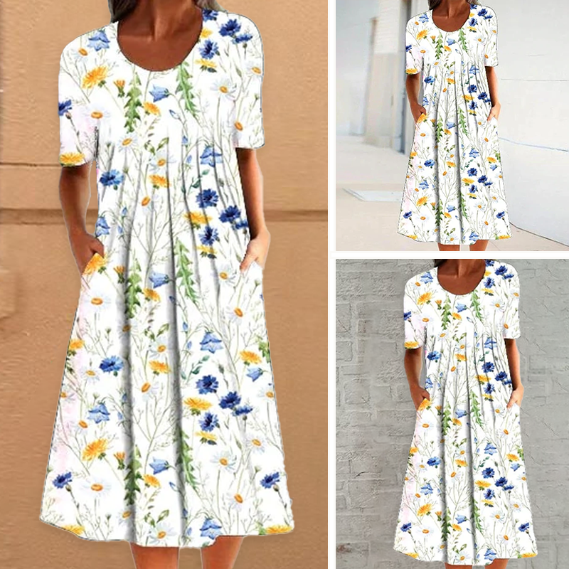 "Elegant blommig A-linje sommarklänning med rund hals i vitt, blått och gult, perfekt för sommardagar och fester."