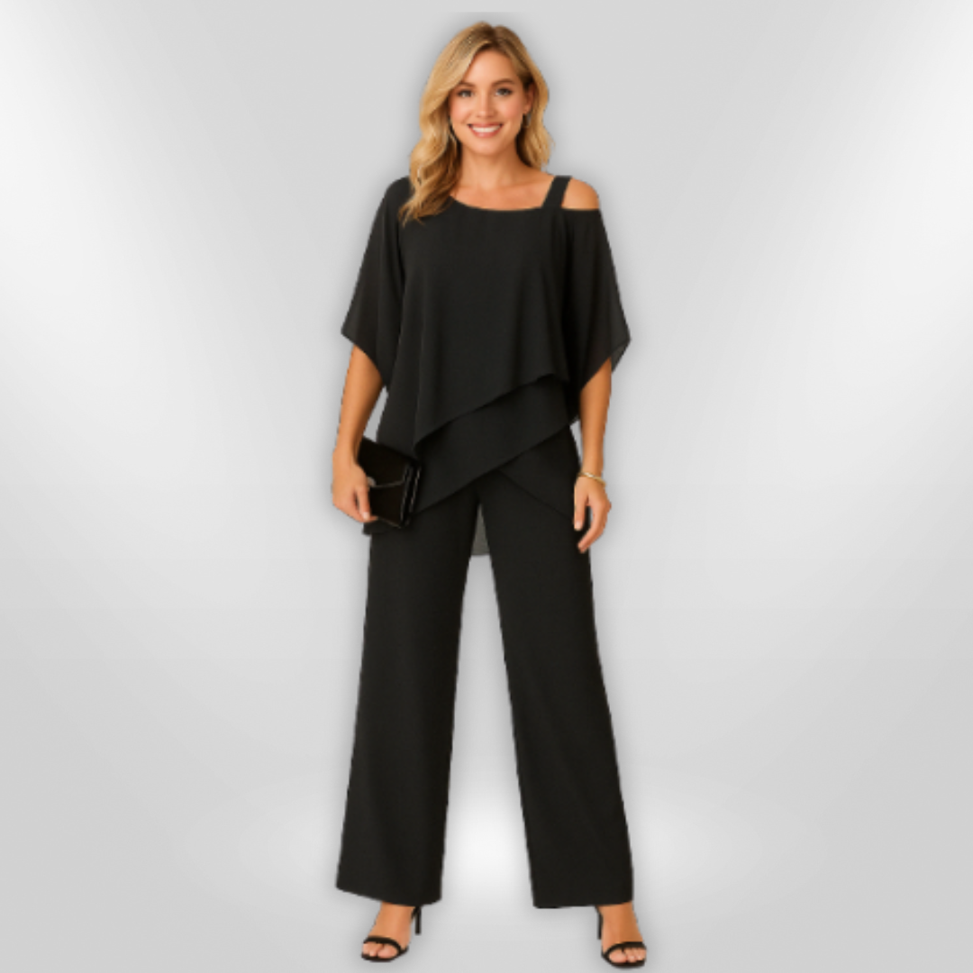 "Elegant damset med svart asymmetrisk topp och vida byxor som kombinerar stil och komfort för sofistikerade tillfällen."