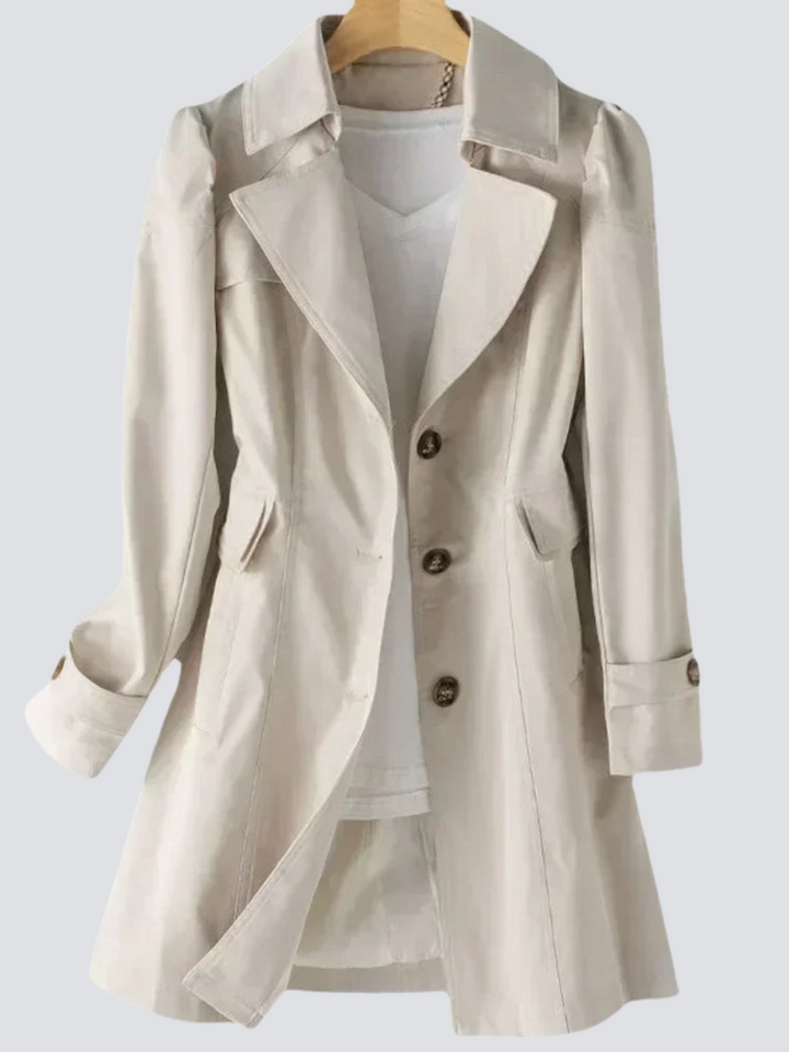 "Elegant damtrenchcoat i midi-längd med knappar, perfekt för höst/vinter. Visad i svart, långärmad, casual stil."