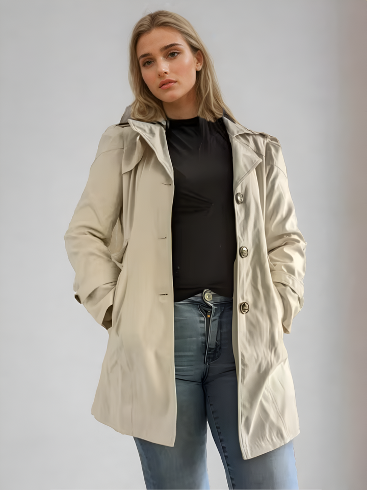 "Elegant damtrenchcoat i midi-längd med knappar, perfekt för höst/vinter. Visad i svart, långärmad, casual stil."