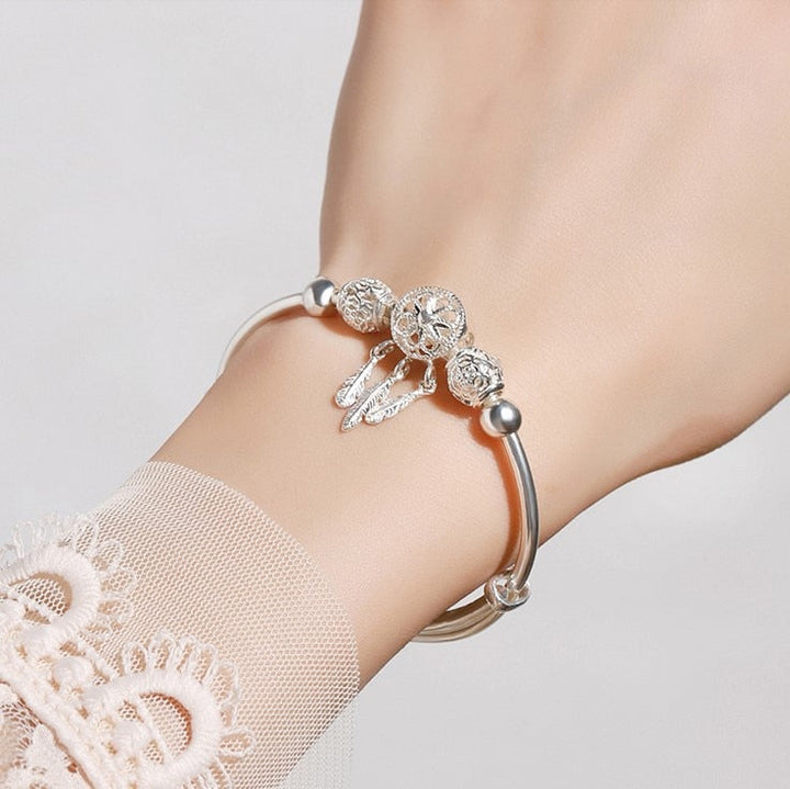 "Elegant drömfångare armband i sterling silver med detaljerade pärlor, sprider positiv energi och förhöjer varje outfit."