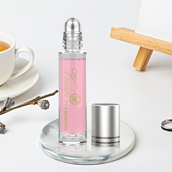 "Elegant flaska med rosa/guld toner, 10ml feromonparfym för män och kvinnor, förstärker naturlig attraktion."