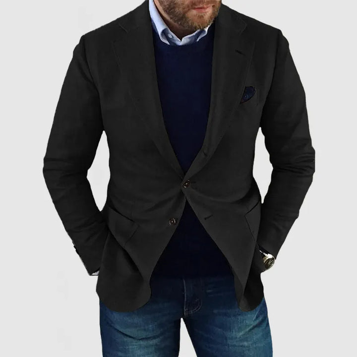 "Elegant herrblazer med tidlös design, mörkgrå färg, lång ärm, på modell, stilfullt sofistikerad look."