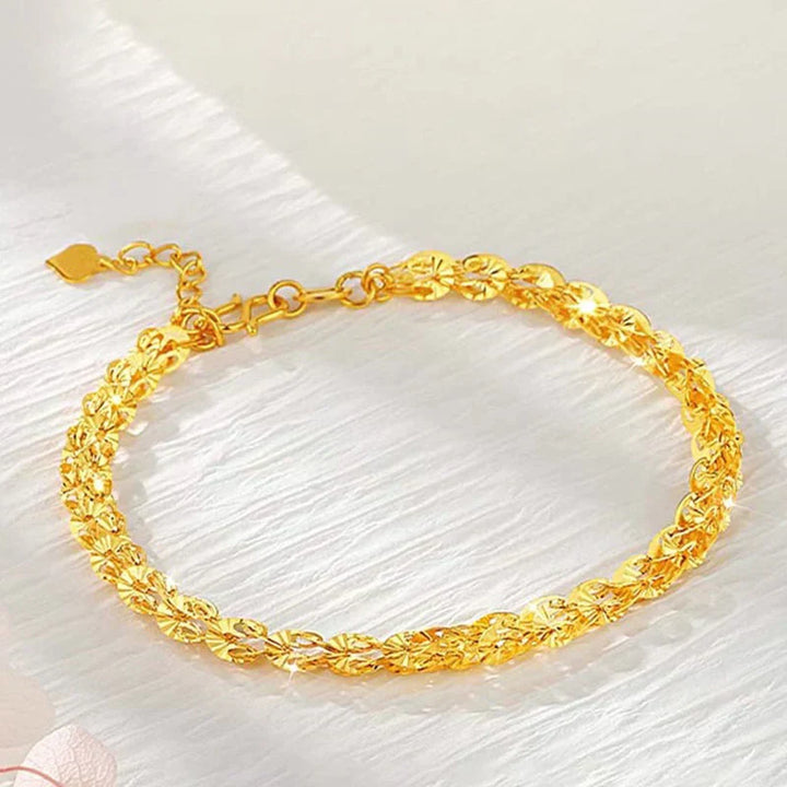 "Elegant justerbart Phoenix armband i guld/silver med unikt fjädermotiv, perfekt kvinnligt smycke för alla tillfällen."