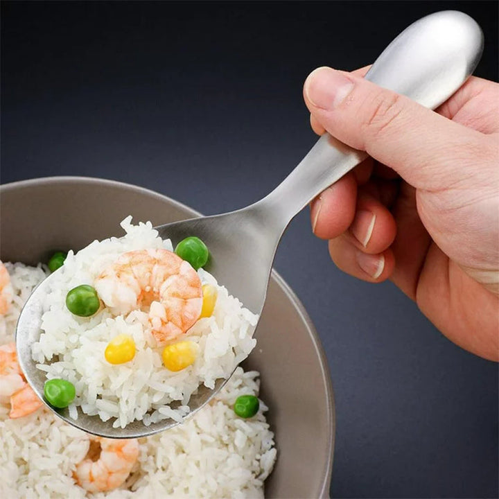 "Elegant och förtjockad non-stick rissked i rostfritt stål med ergonomiskt grepp, perfekt för kök och servering."