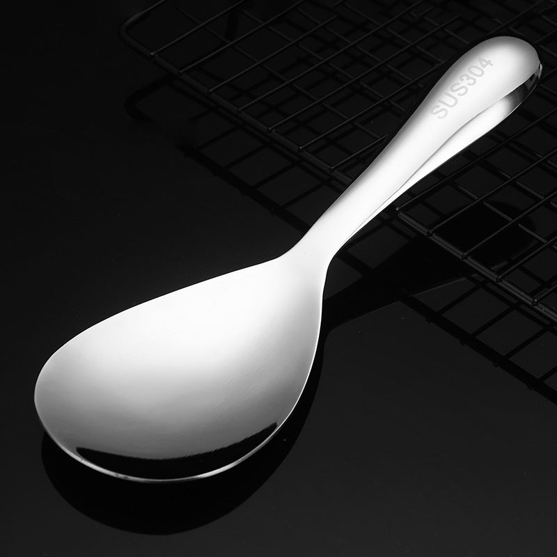 "Elegant och förtjockad non-stick rissked i rostfritt stål med ergonomiskt grepp, perfekt för kök och servering."
