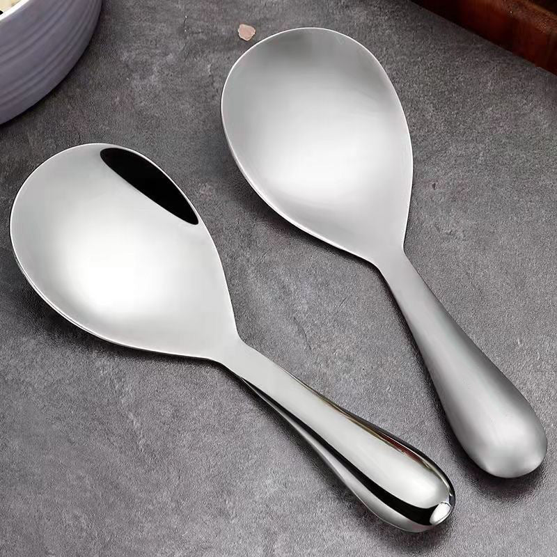 "Elegant och förtjockad non-stick rissked i rostfritt stål med ergonomiskt grepp, perfekt för kök och servering."