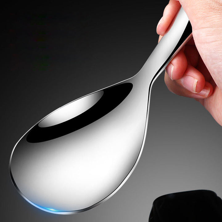 "Elegant och förtjockad non-stick rissked i rostfritt stål med ergonomiskt grepp, perfekt för kök och servering."