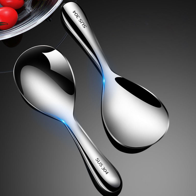 "Elegant och förtjockad non-stick rissked i rostfritt stål med ergonomiskt grepp, perfekt för kök och servering."
