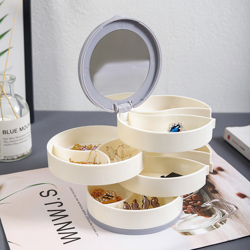 "Elegant roterande smyckesskrin med flera lager, spegel och LED-belysning för smidig och lyxig smyckesförvaring."