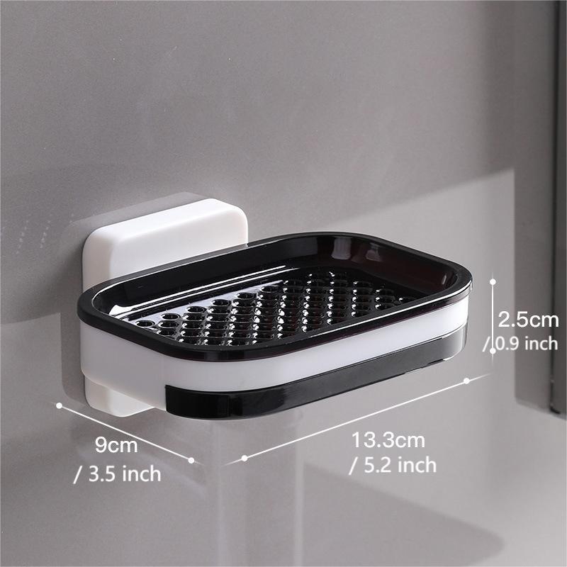 "Elegant svart och grå tvålkopp med avtappningsbricka, stilren design, glansig bakgrund, perfekt för badrumshylla."