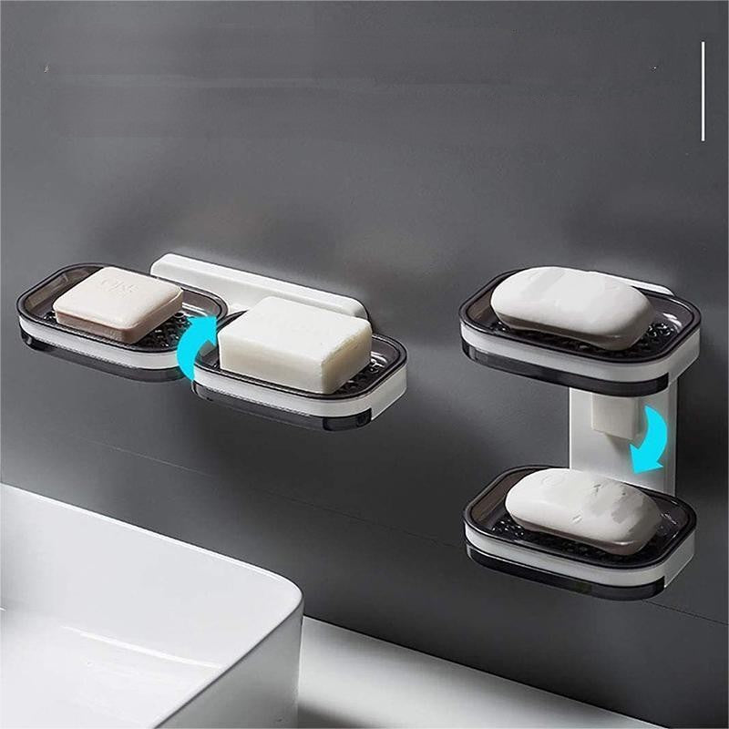 "Elegant svart och grå tvålkopp med avtappningsbricka, stilren design, glansig bakgrund, perfekt för badrumshylla."