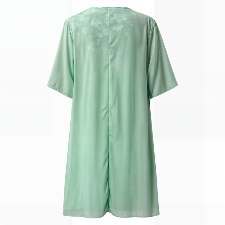 "Eleganta blommig klänning, vintage stil, A-line siluett, feminin design, perfekt för vårfest eller solig dag ute."