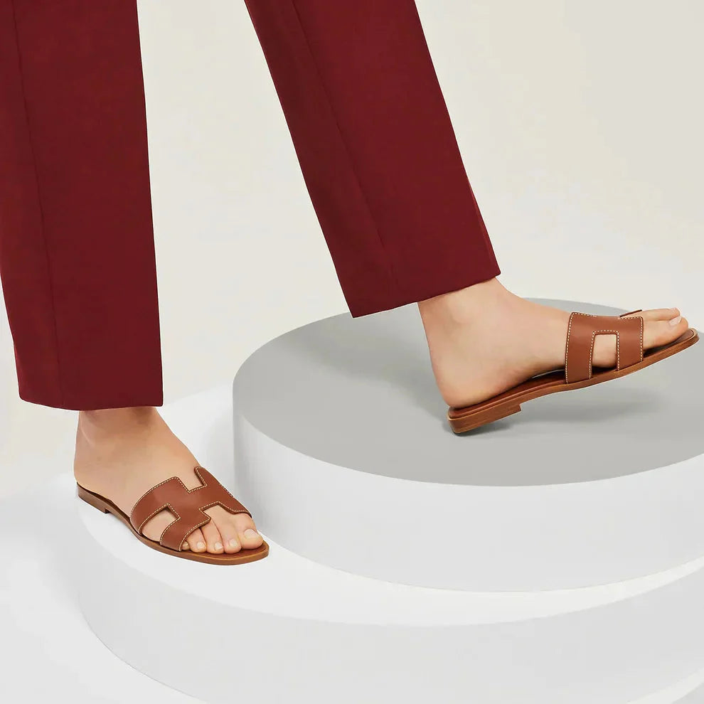 "Eleganta slip-on sandaler för kvinnor i stilrent H-mönster, platta med chic design, idealiska för sommardagar."