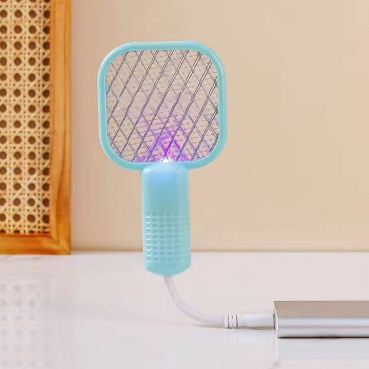 "Elektrisk myggsmällare i svart, vit, rosa, grön för effektiva insektborttagning inomhus/utomhus, stilren design."
