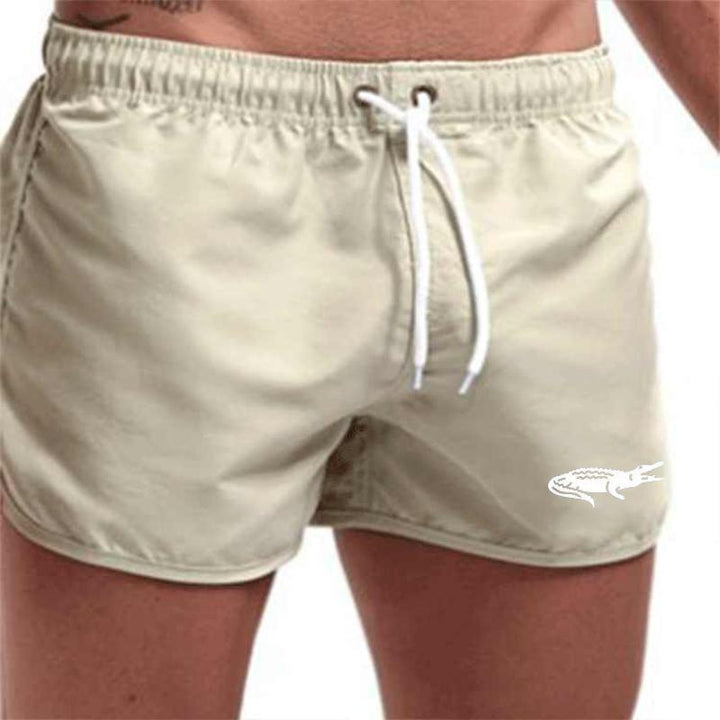"Enfärgade herr badshorts med krokodilmönster i polyester, perfekt för sommar, tillgängliga i flera färger."