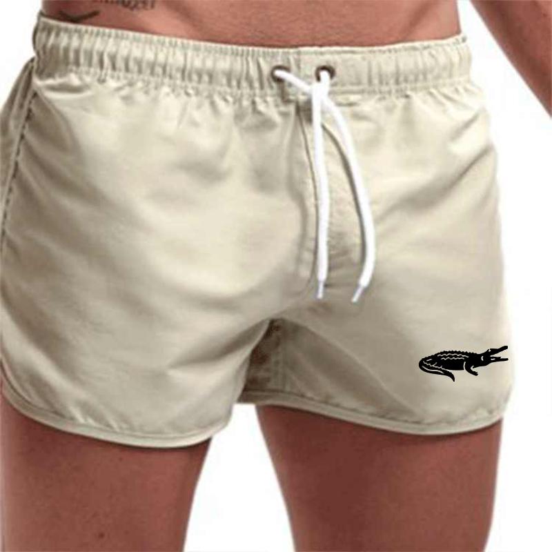 "Enfärgade herr badshorts med krokodilmönster i polyester, perfekt för sommar, tillgängliga i flera färger."