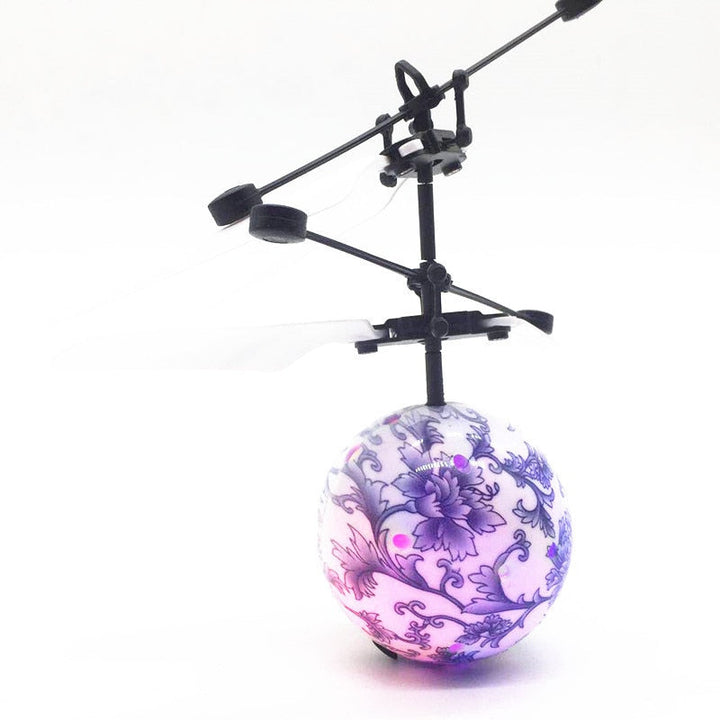 Flygande LED leksak som svävar över en gräsmatta i solsken.