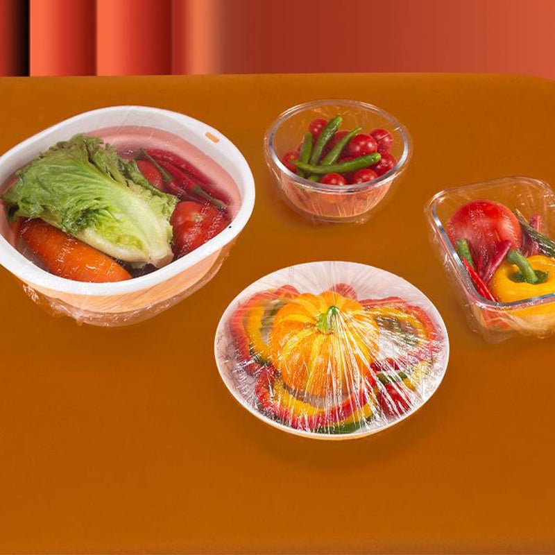 "Genomskinliga PE-plastpåsar med elastiska band för matförvaring; luktfria, giftfria och idealiska för köksanvändning."