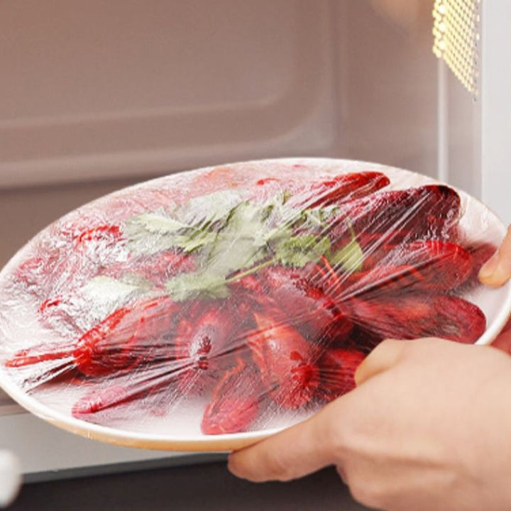 "Genomskinliga PE-plastpåsar med elastiska band för matförvaring; luktfria, giftfria och idealiska för köksanvändning."