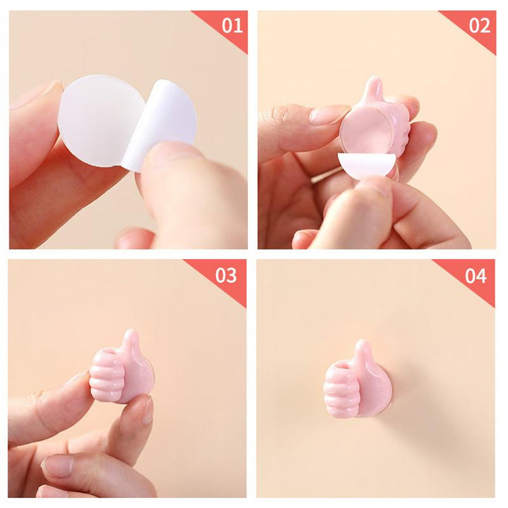 "Grön självhäftande Tumme Upp kabelhållare på slät yta, effektivt organiserar kablar, passar dator- och USB-kablar."