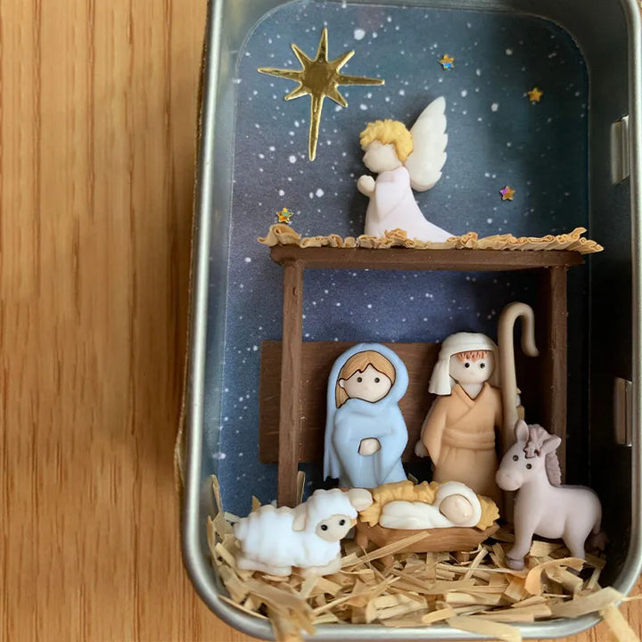 "Handgjord julkrubba med figurer som Maria, Josef, Jesus under stjärnklar natt, perfekt för festlig dekoration."