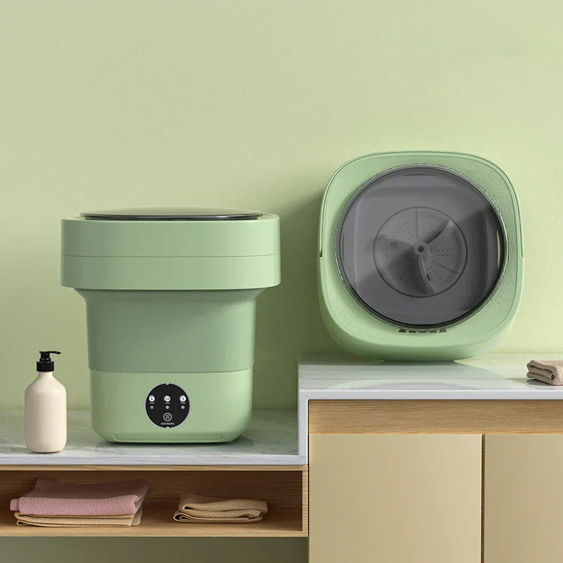 "Hopfällbar portabel tvättmaskin med kompakt design, 6L kapacitet, vit och blå detaljer för effektiv tvätt."