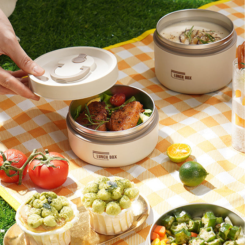 "Isolerad bärbar lunchlåda i blått, brun och beige. Vakuumisolerad för värme och läckagesäker design för mat på språng."