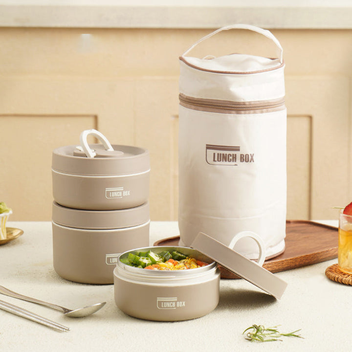 "Isolerad bärbar lunchlåda i blått, brun och beige. Vakuumisolerad för värme och läckagesäker design för mat på språng."