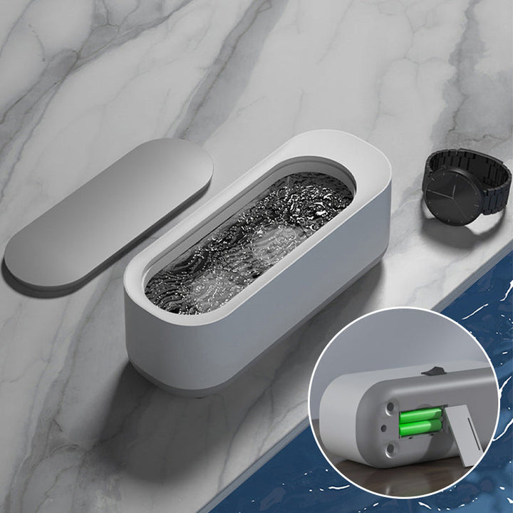 "Kompakt vit och grå ultraljudsrengöringsmaskin, idealisk för smycken och glasögon, bärbar och effektiv rengöring."