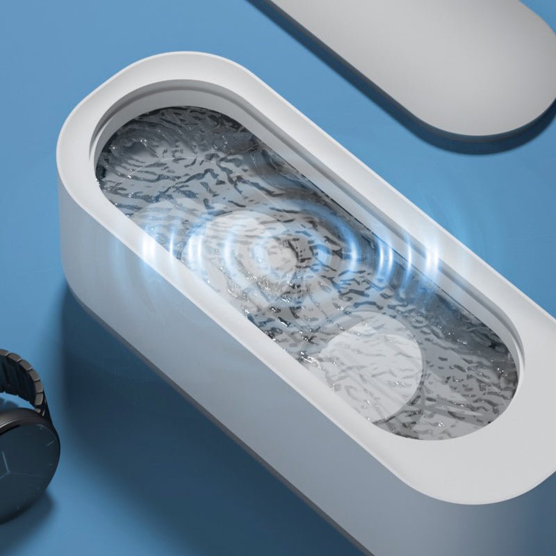 "Kompakt vit och grå ultraljudsrengöringsmaskin, idealisk för smycken och glasögon, bärbar och effektiv rengöring."