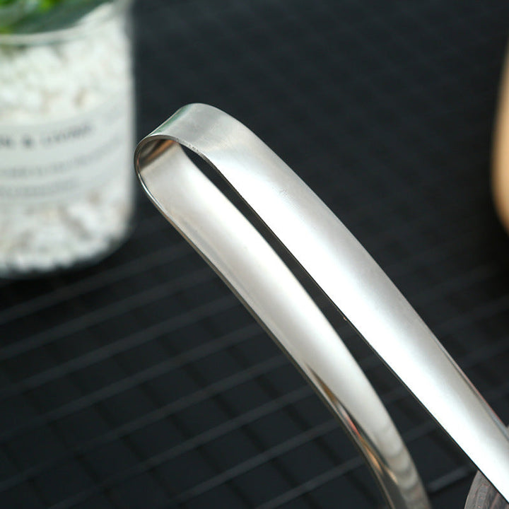 "Köttbullssked av rostfritt stål, silverfärgad, med ergonomiskt handtag och håldesign, perfekt för köttbullsformning."