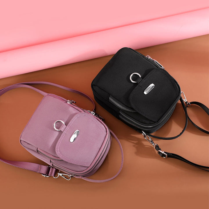 "Lätt vattentät unisex crossbody-väska i nylon med flera fickor, justerbar axelrem, kompakt och funktionell design"