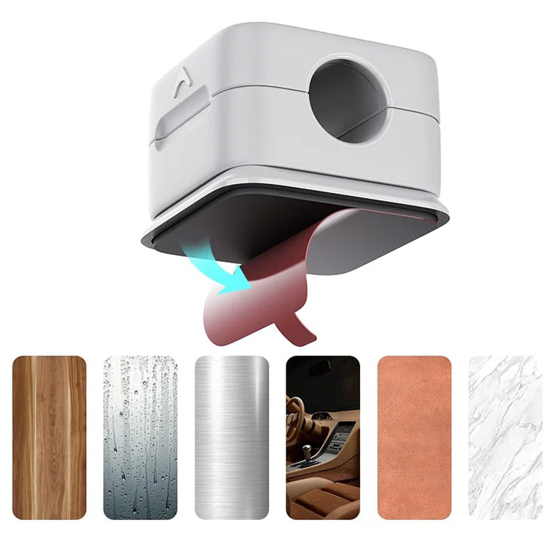 "Magnetisk kabelhållare håller kablar organiserade, stilren design i svart och vit, passar kablar upp till 7 mm."