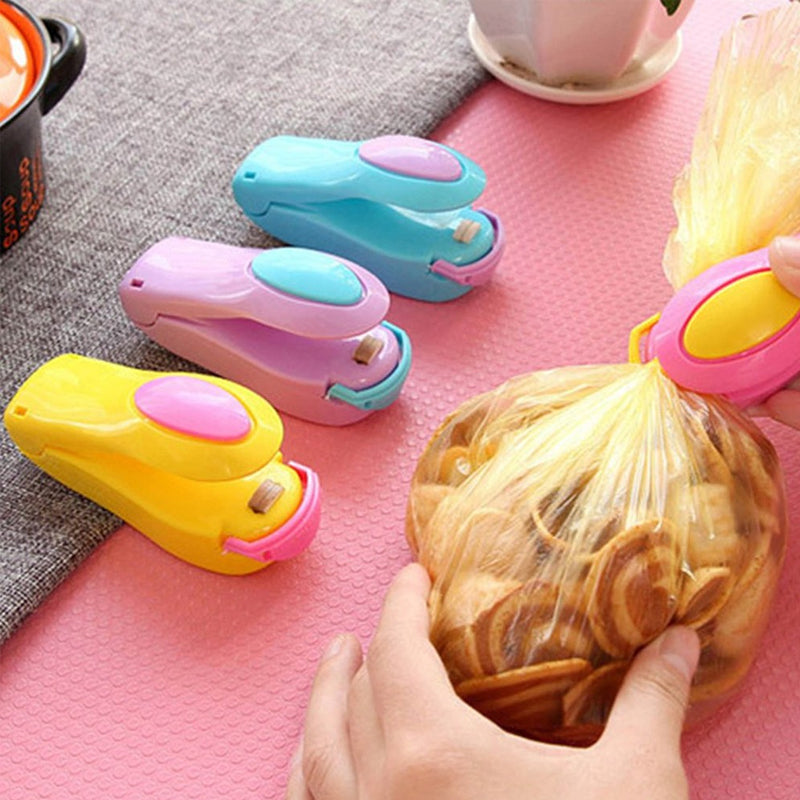 "Mini bärbar värmeförsegling för hushåll, blå, rosa, grön, gul, kompakt, magnetisk bas, matbevarande, enkel att använda."