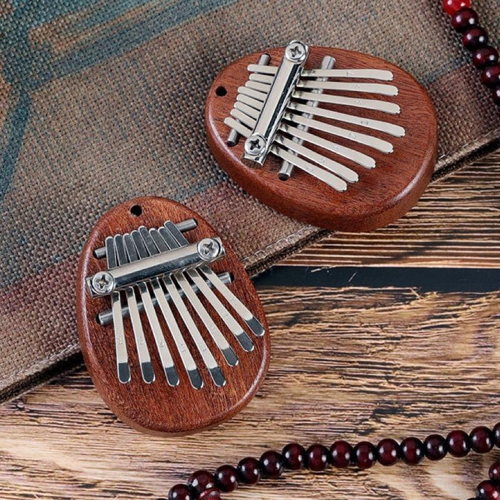 "Mini tumpiano i trä och kristall med graverade nycklar. Perfekt för musikälskare i alla åldrar, kompakt och elegant."