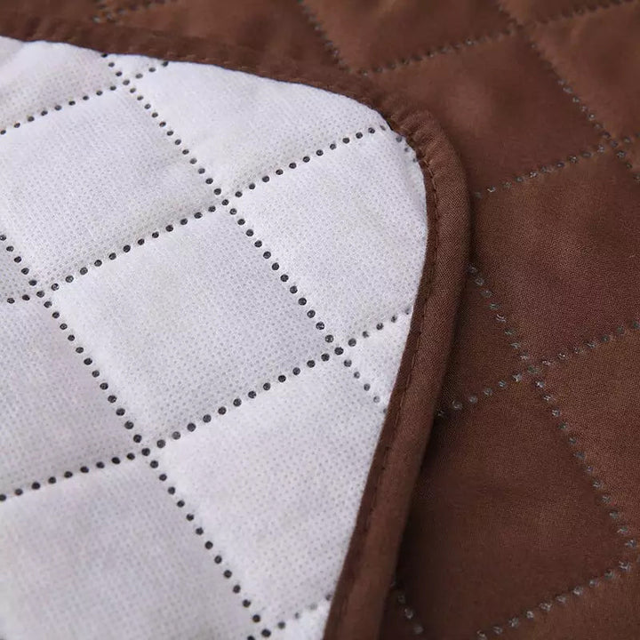 "Mjukt vilstolsöverdrag i grått polyester/fleece som skyddar och omvandlar fåtöljen till en inbjudande viloplats."