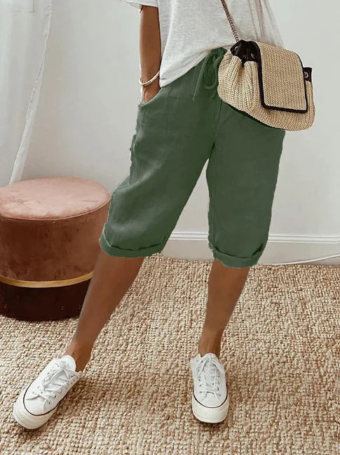 Monokroma bomullsblandningsbyxor för dam med sidfickor, utmärkta för en skön och avslappnad stil.