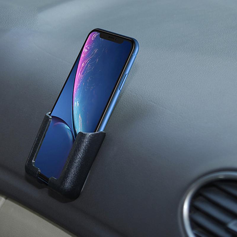 "Multifunktionell telefonfäste i lädertextur, stark adhesive, säker hållning, lämplig för bil, skrivbord, hemmabruk."