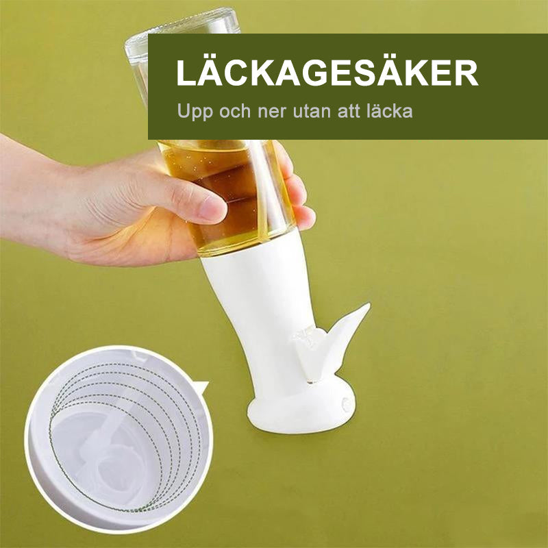 "Multifunktionell transparent oljesprayflaska i PET-plast med lufttrycksystem, svart och vit färg, för köket."